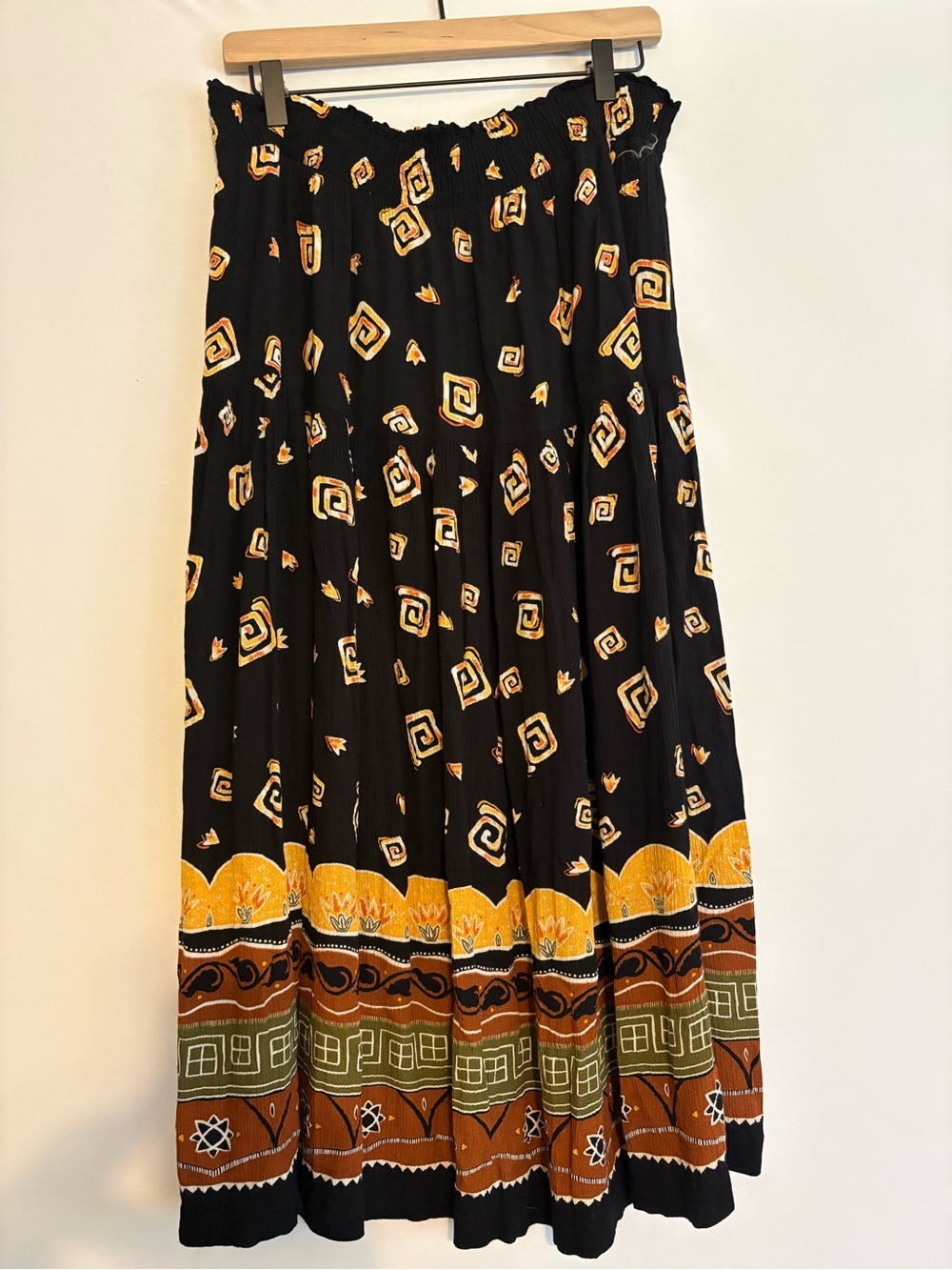 Black patterned tiered maxi skirt with elastic waist and pockets